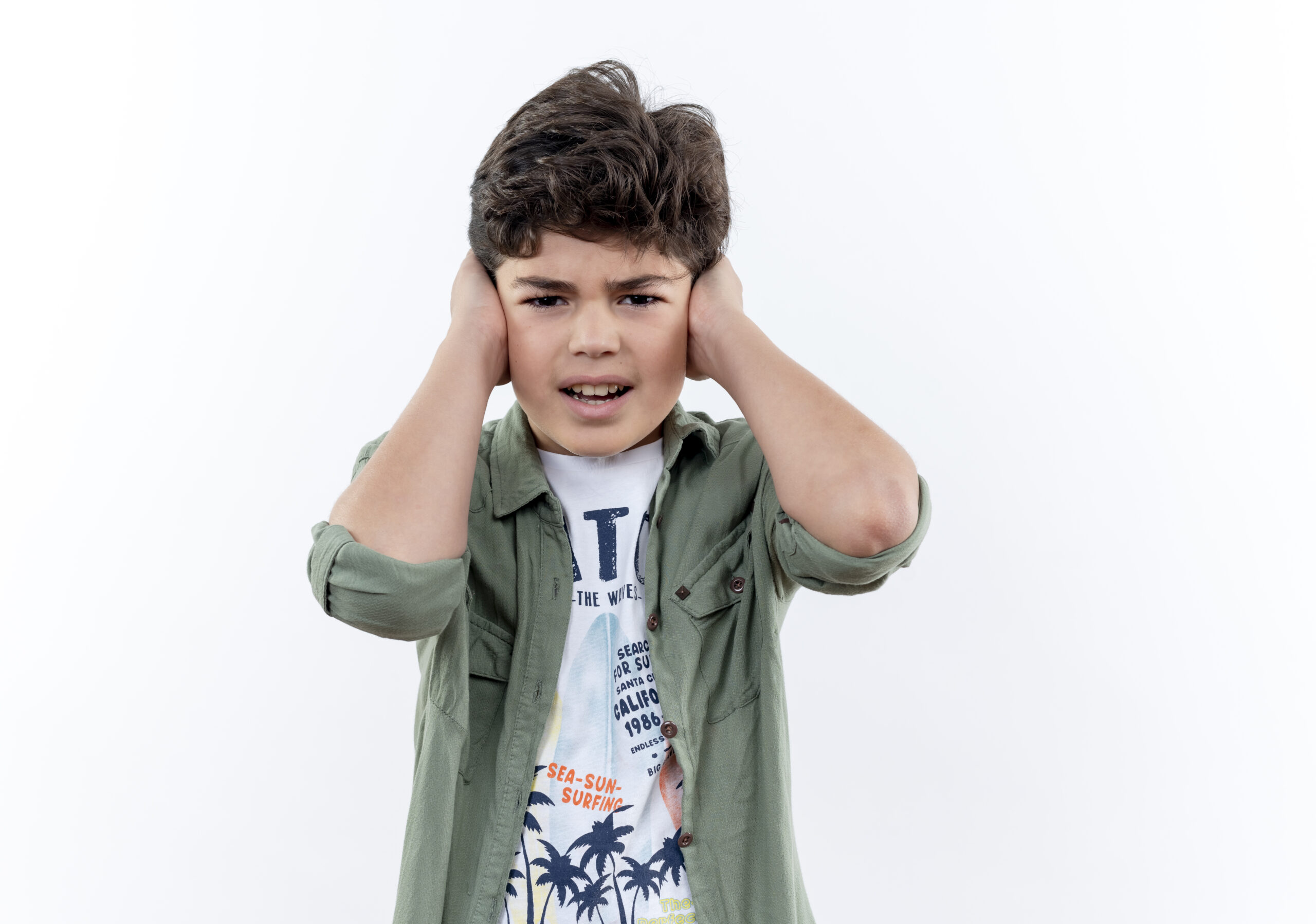 A young child covers both ears in discomfort, illustrating the pain and distress commonly caused by acute otitis media