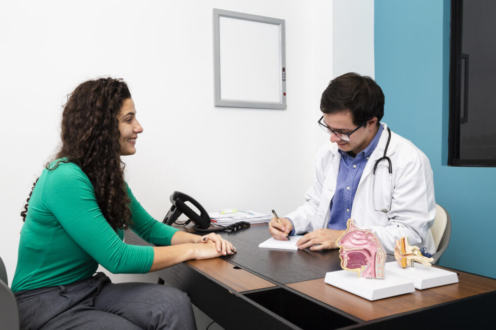An ENT specialist consults with a patient about rhinoplasty, discussing nasal concerns and treatment options.