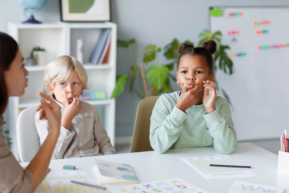 A speech therapy session where children practice sounds and mouth movements with guidance from a therapist, supporting clearer speech, communication skills, and language development.