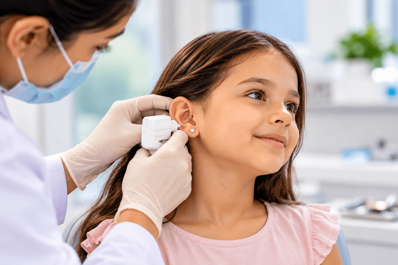 a professional ear-piercing procedure for a child