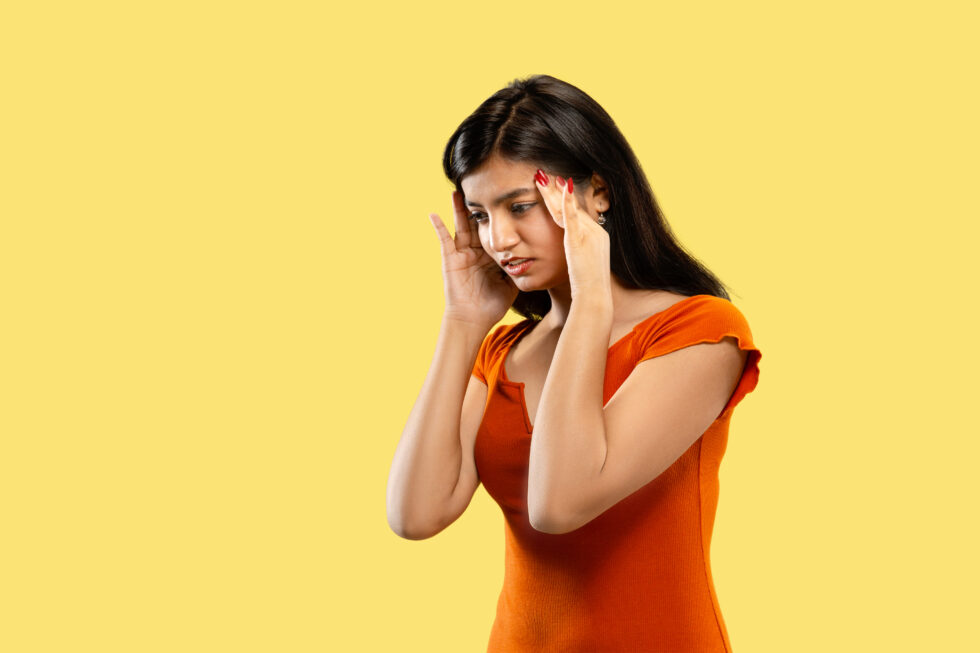 a young woman experiencing a headache or migraine.