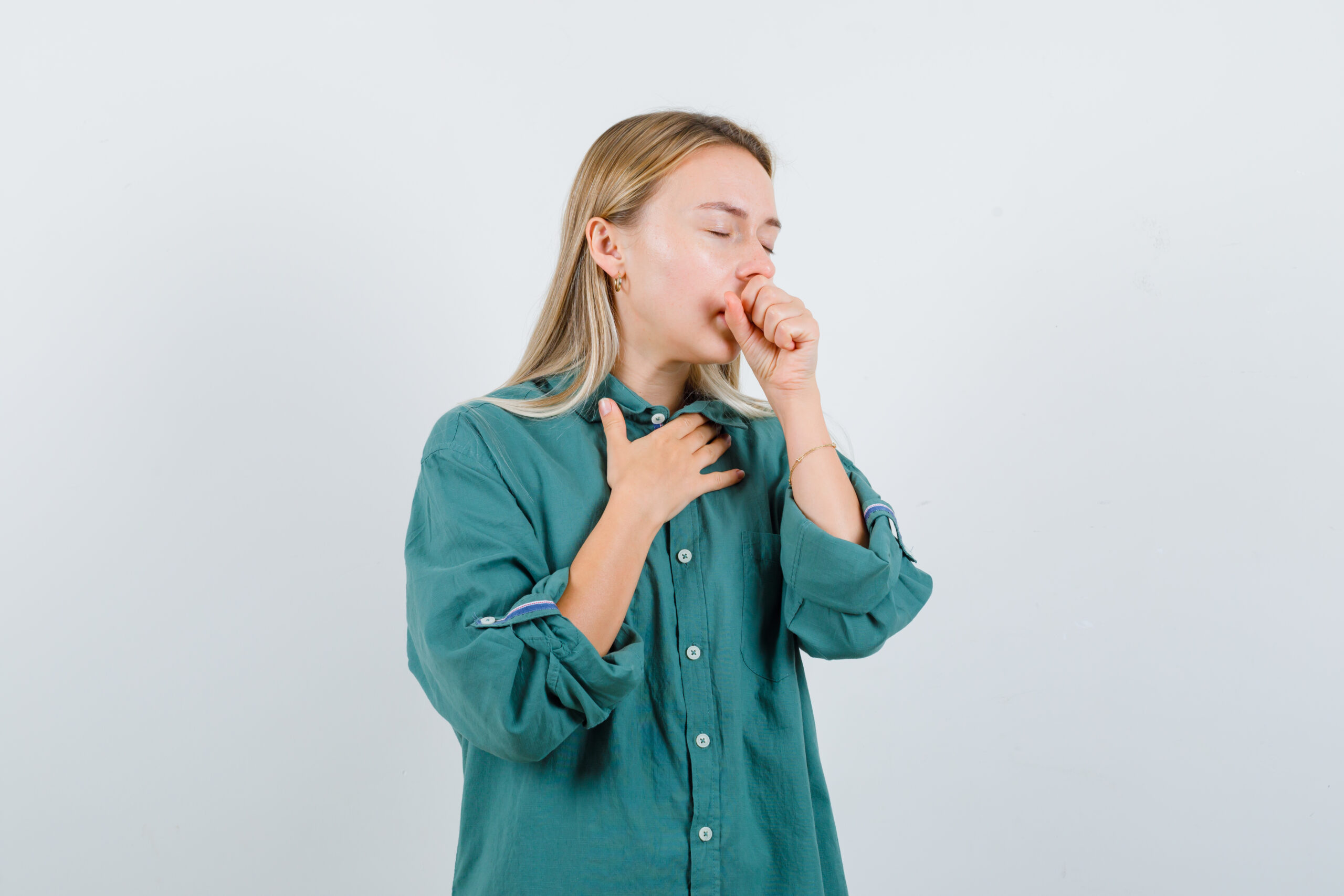 a woman experiencing throat irritation and coughing.
