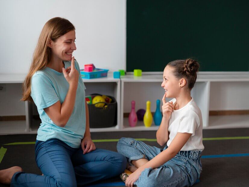 a speech therapy or communication practice session between an adult therapist and a young girl.